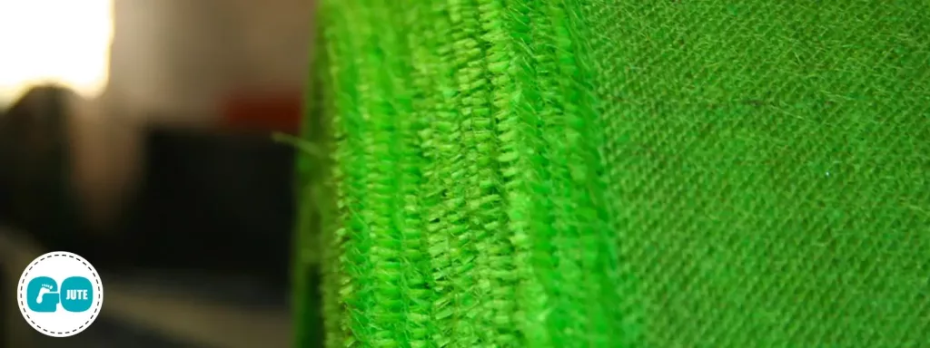 close up of jute fabric, dyed green, on a roll
