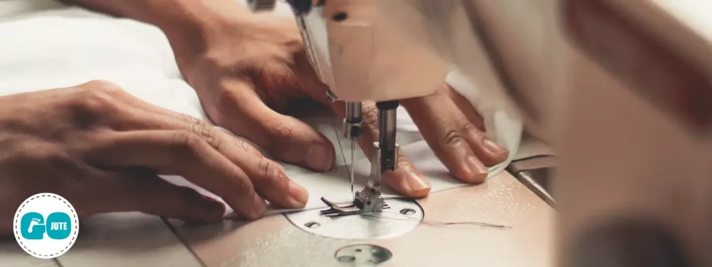 hands working fabric through a sewing machine