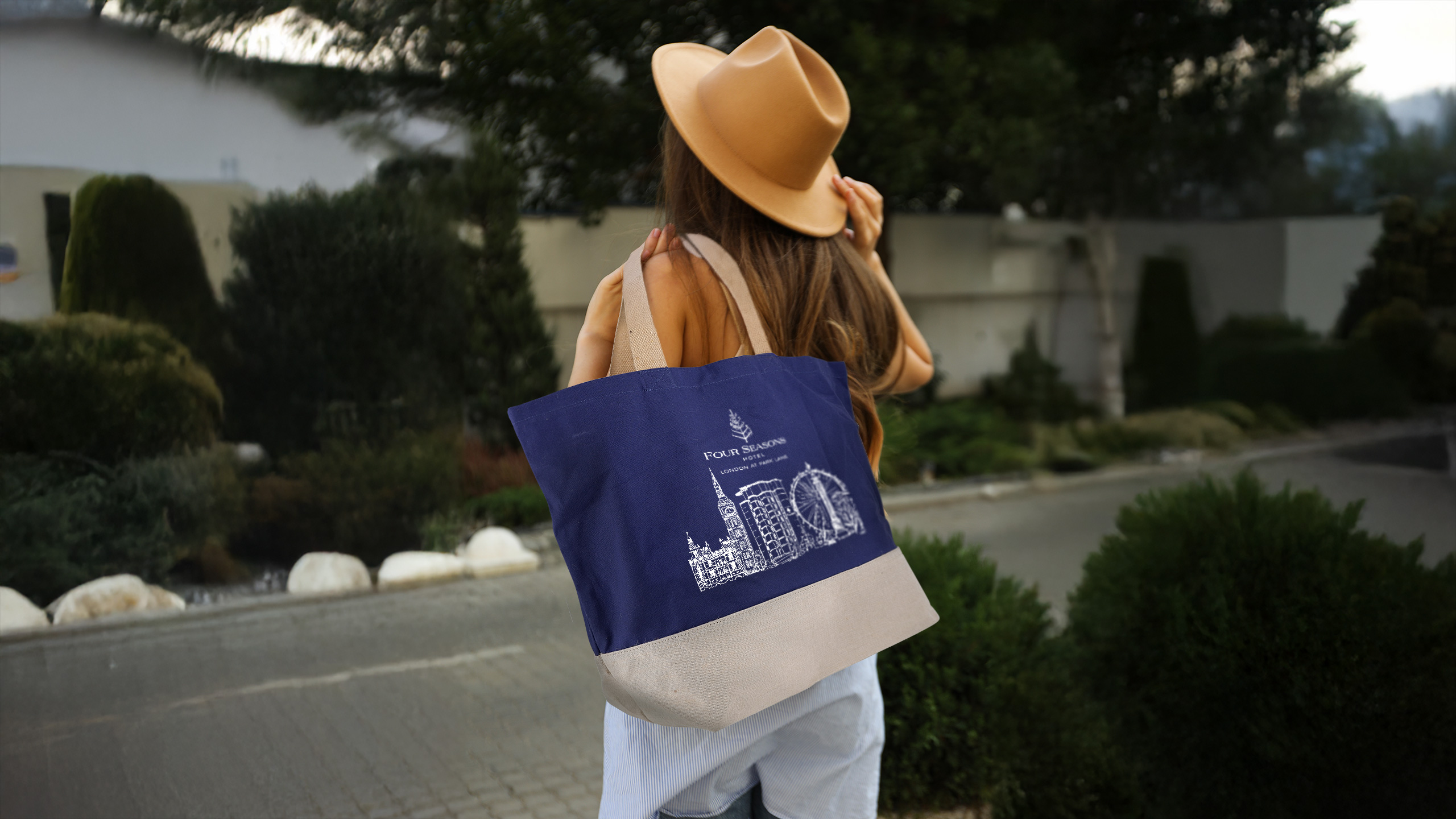 Person holding a branded jute shopping bag