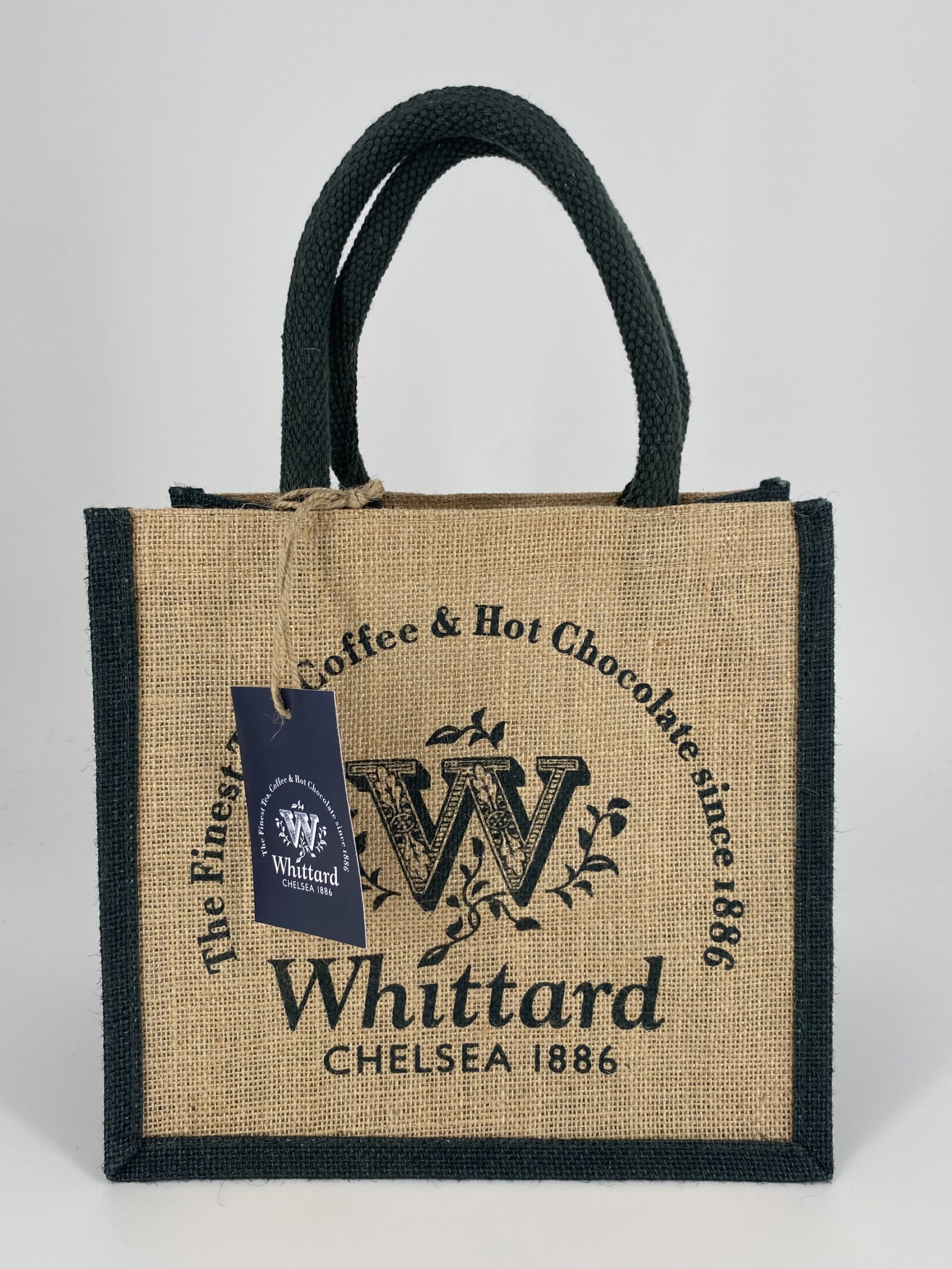 Person holding a branded jute shopping bag
