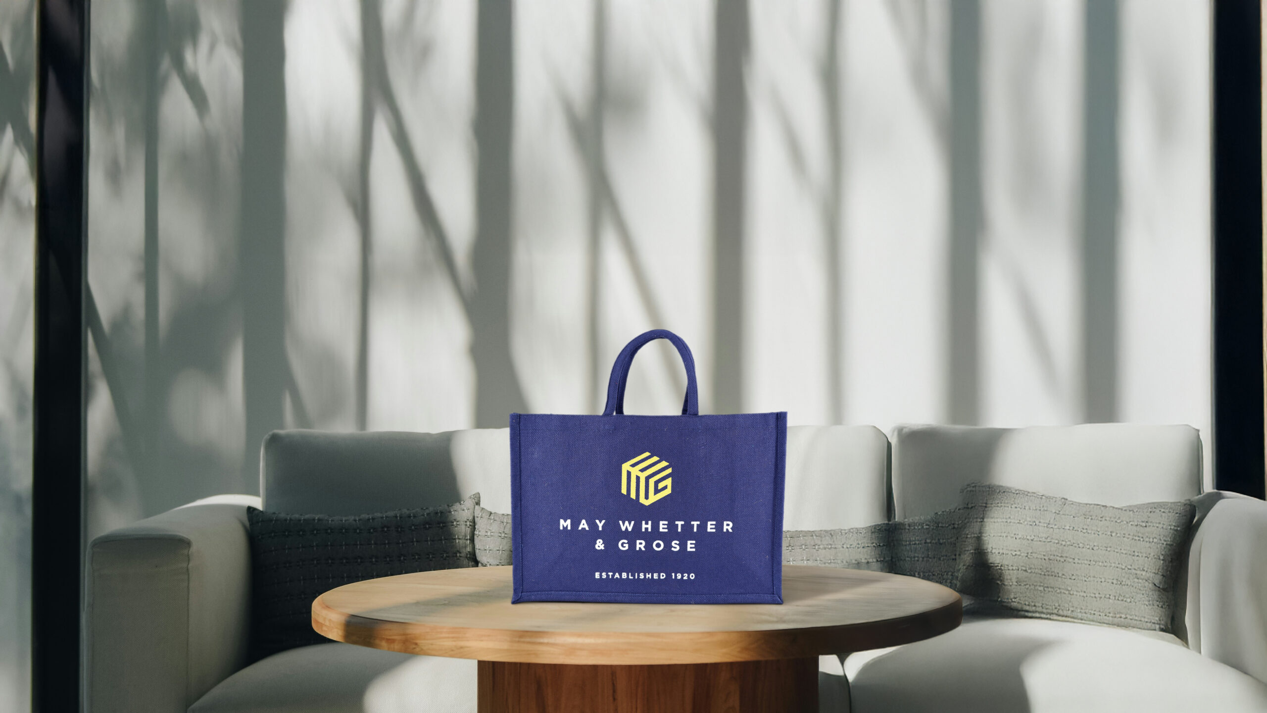 Person holding a branded jute shopping bag