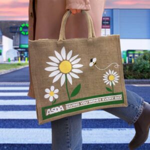 A person carrying an ASDA sustainable natural jute bag by GoJute